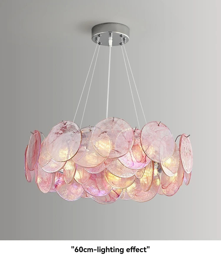 Pink chandelier with multiple circular shades on a gray background
