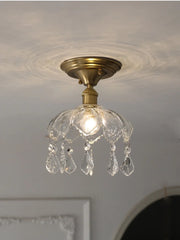 Ceiling light fixture with crystal accents on a neutral ceiling