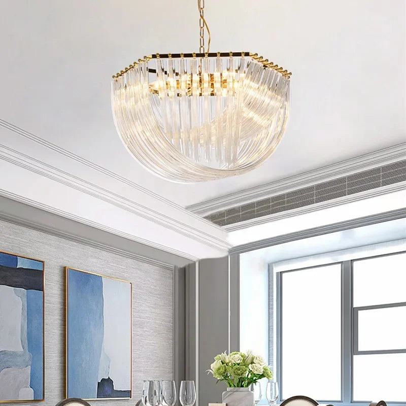 Close-up of a gold crystal waterfall chandelier showcasing its intricate design and polished gold finish, hanging in a dining room.