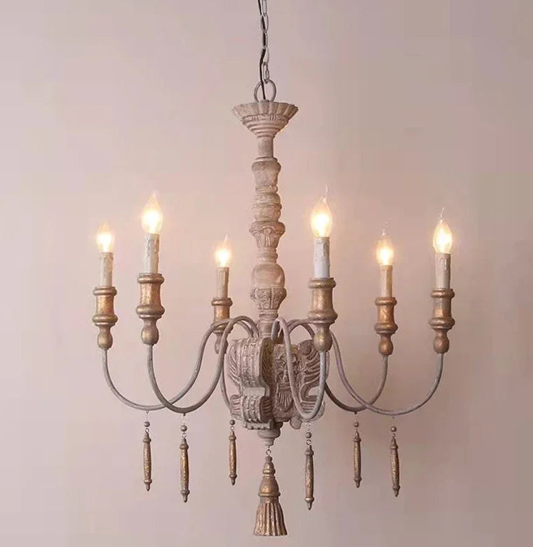 Wooden chandelier with six lights on a plain background