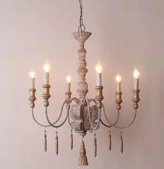 Wooden chandelier with six lights on a plain background