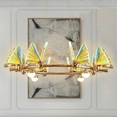 Gold ring chandelier with translucent yellow and blue butterfly-shaped shades and globe lights.