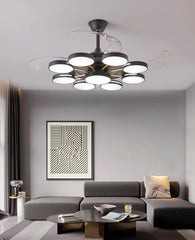 Modern living room with a ceiling light fixture, gray sofa, and abstract wall art.