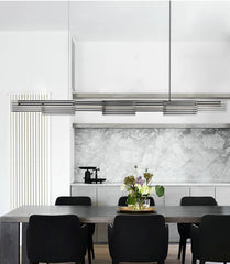 Modern kitchen with marble backsplash and dining table setup