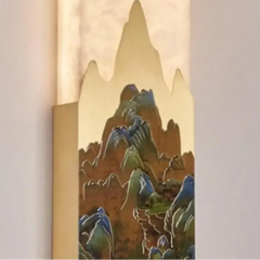 Decorative wall sconce with mountain design on a neutral background