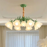 Green floral-shaped pendant light with frosted glass shades hanging from a green ceiling mount.