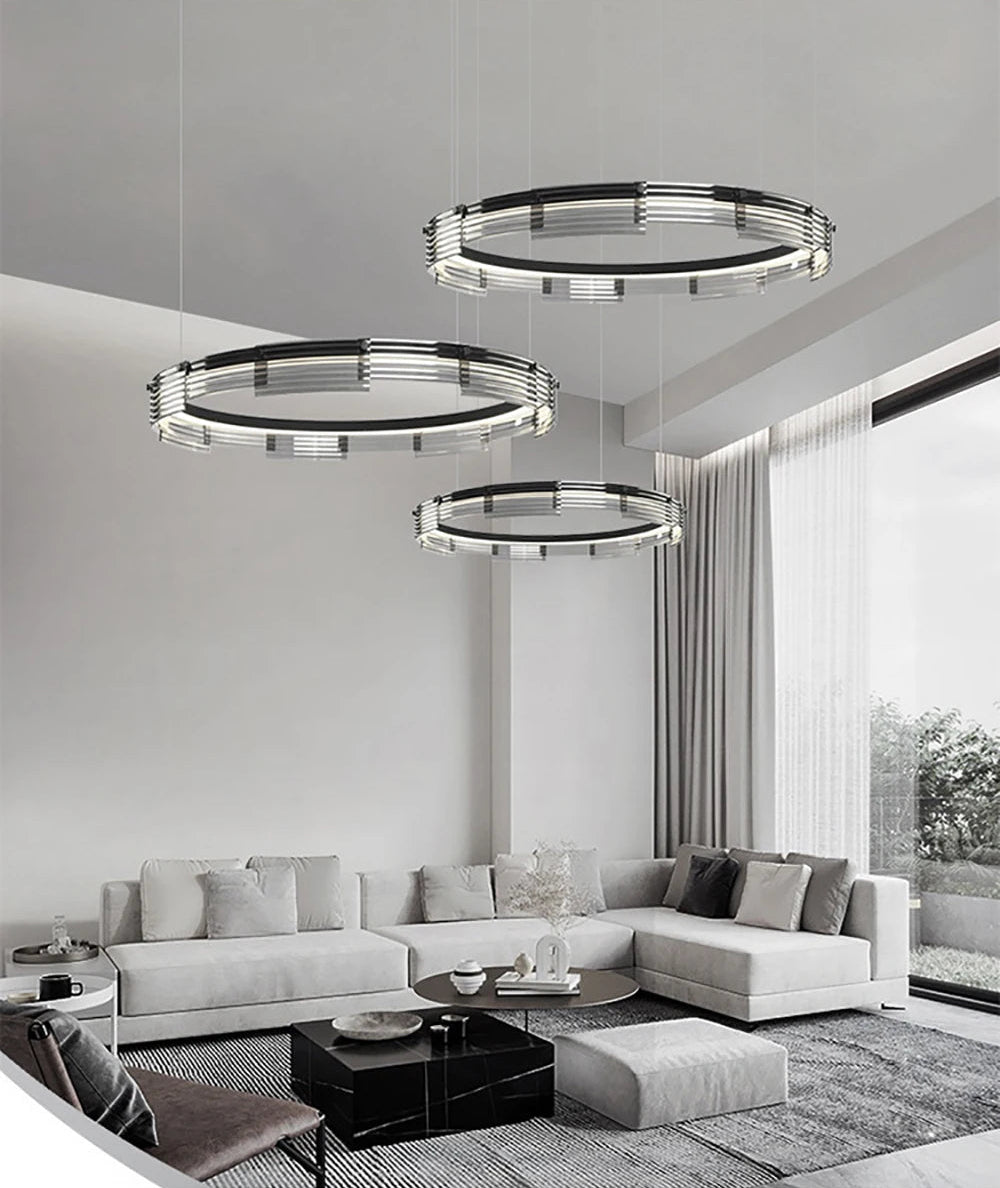 Modern living room with circular pendant lights and a sectional sofa.