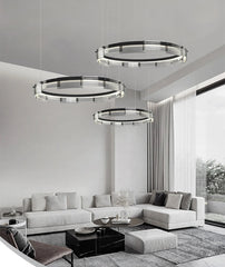 Modern living room with circular pendant lights and a sectional sofa.