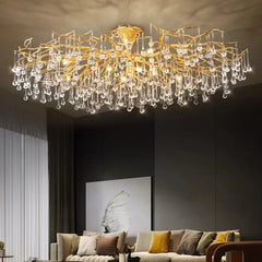 A large gold branch crystal chandelier suspended from a white ceiling, showcasing its intricate design.