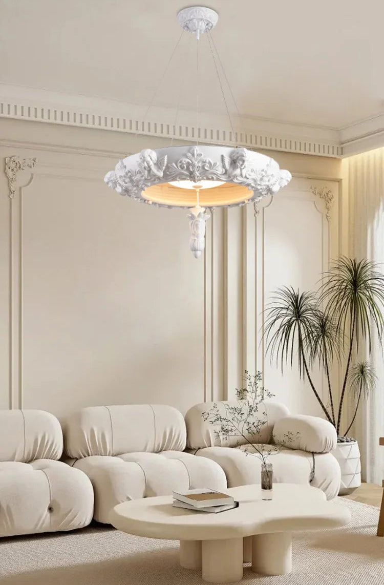 Modern living room with a beige sectional sofa, round coffee table, and decorative plants.