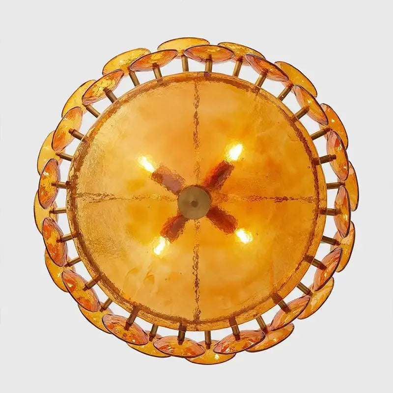Round amber-colored light fixture with a clear background