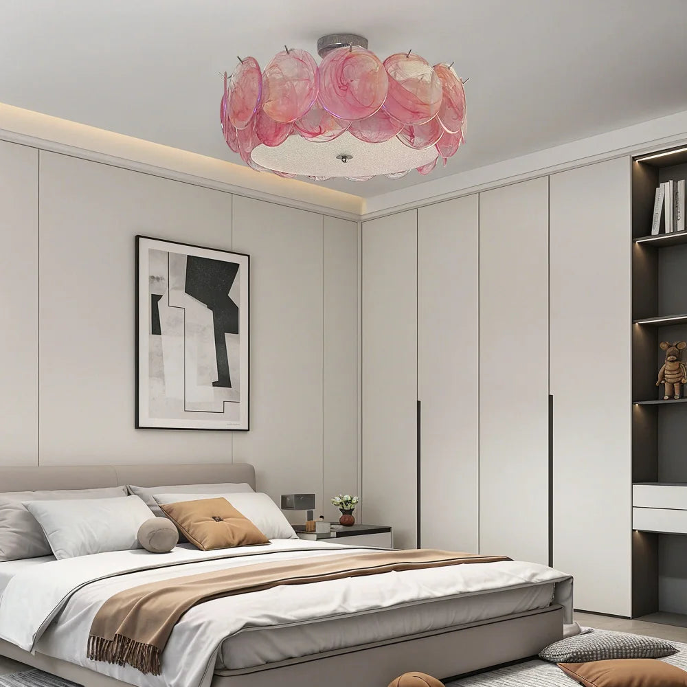 Pink glass floral flush mount ceiling light in a modern bedroom with minimalist decor.
