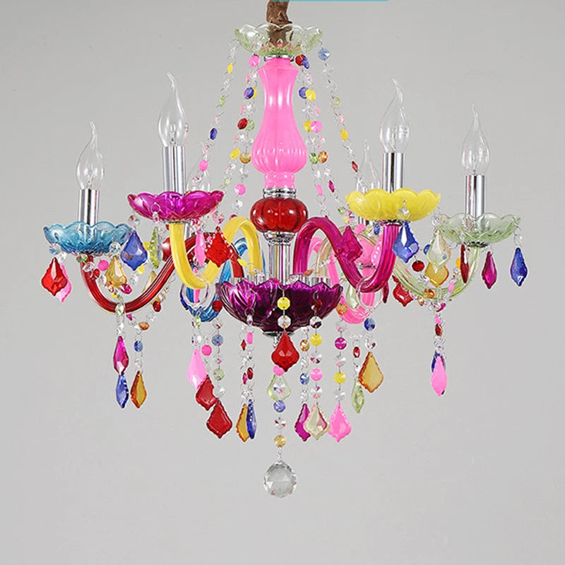 A brightly colored chandelier with ornate arms, crystal drops, and five illuminated bulbs, showcasing its festive and playful design.
