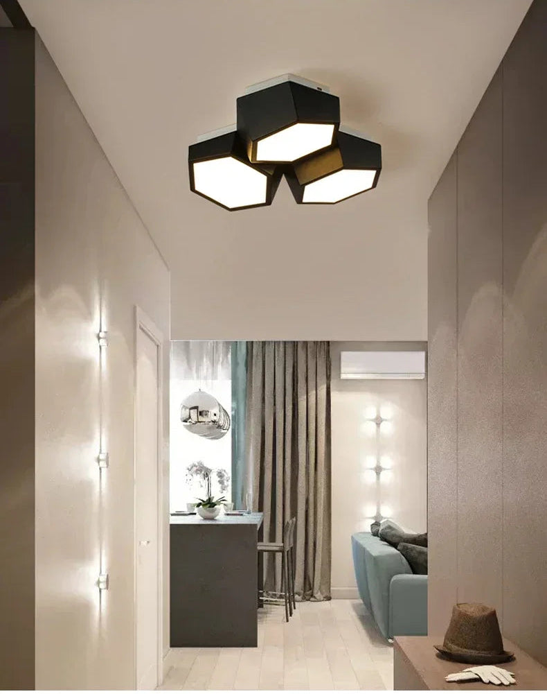 Modern ceiling light fixture in a stylish interior setting with a living room and kitchen.