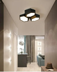 Modern ceiling light fixture in a stylish interior setting with a living room and kitchen.