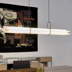Modern pendant light fixture in a room with a painting on the wall.