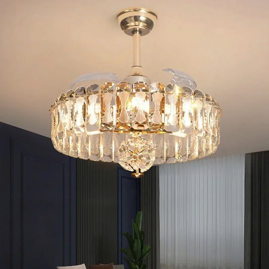 A gold and crystal tiered semi-flush ceiling light with a fan, illuminated and mounted on a white ceiling.