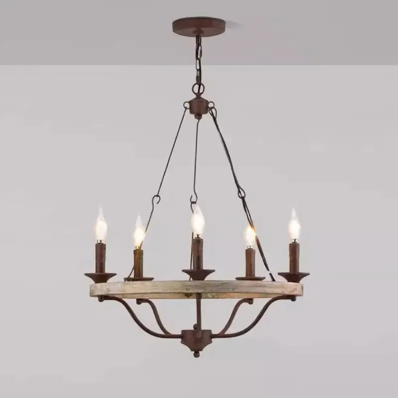 Vintage-style chandelier with five candle-like lights on a plain background