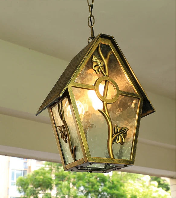 Decorative hanging light fixture with glass cover and metal design, hanging from a ceiling.