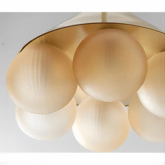 Gold spherical pendant light fixture on a white background