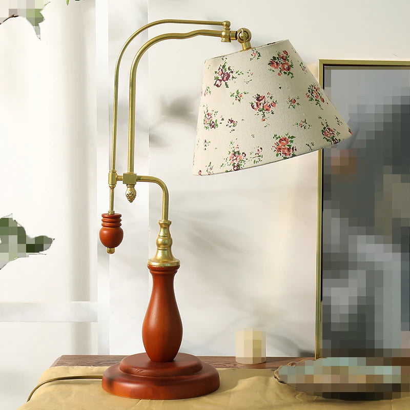 Decorative table lamp with floral shade on a wooden base