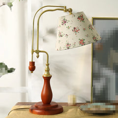 Decorative table lamp with floral shade on a wooden base