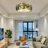 Green glass floral flush mount ceiling light in a modern living room.