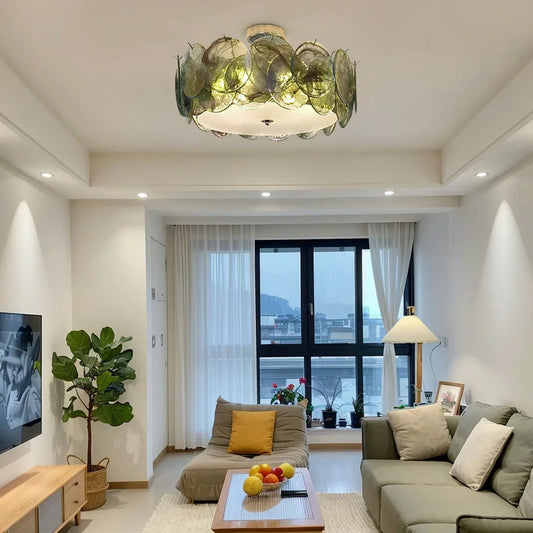 Green glass floral flush mount ceiling light in a modern living room.