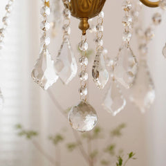 Close-up of a chandelier with crystal beads and gold fixture.