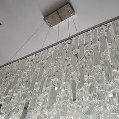 Close-up of a decorative ceiling light fixture with glass tiles.