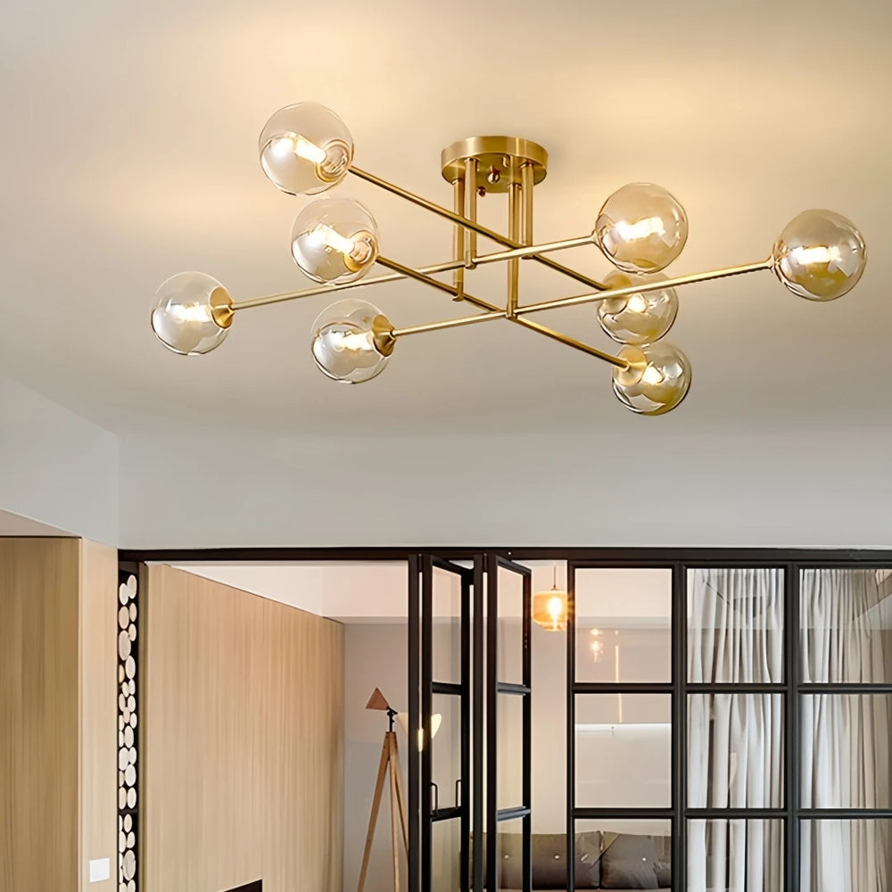 Gold sputnik starburst semi-flush ceiling light installed in a living room with a view of an open doorway