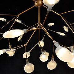 Modern chandelier with multiple light bulbs on a black background