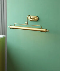 Gold wall-mounted lamp on a green wall