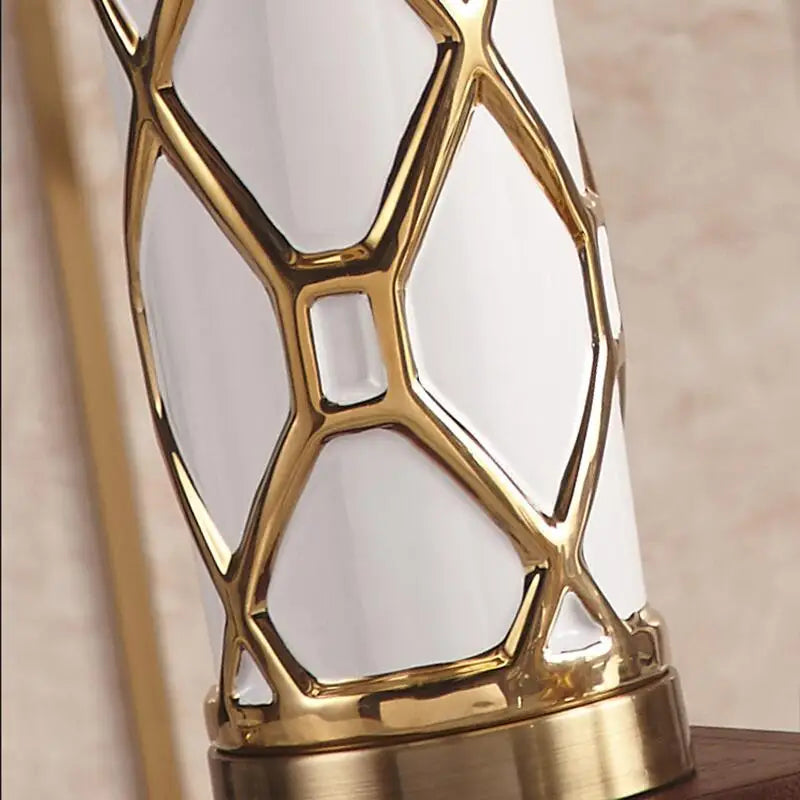 Decorative lamp with gold geometric design on a neutral background