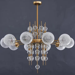 Chandelier with glass bubbles and gold accents on a dark background