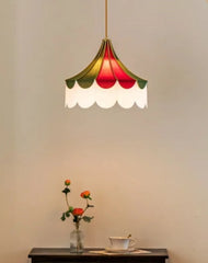 Decorative pendant light with scalloped edge design on a plain wall.
