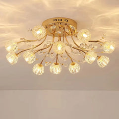 Gold semi-flush mount ceiling light with floral design and clear crystal accents, lit up