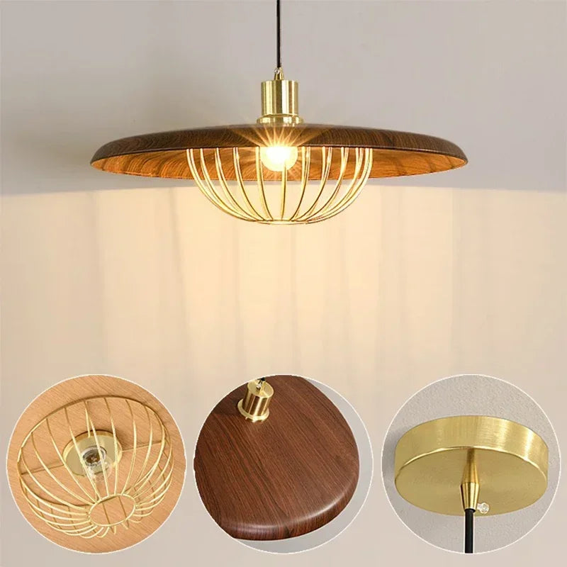Close-up of a wood-finish pendant light with a gold wire cage surrounding the bulb.