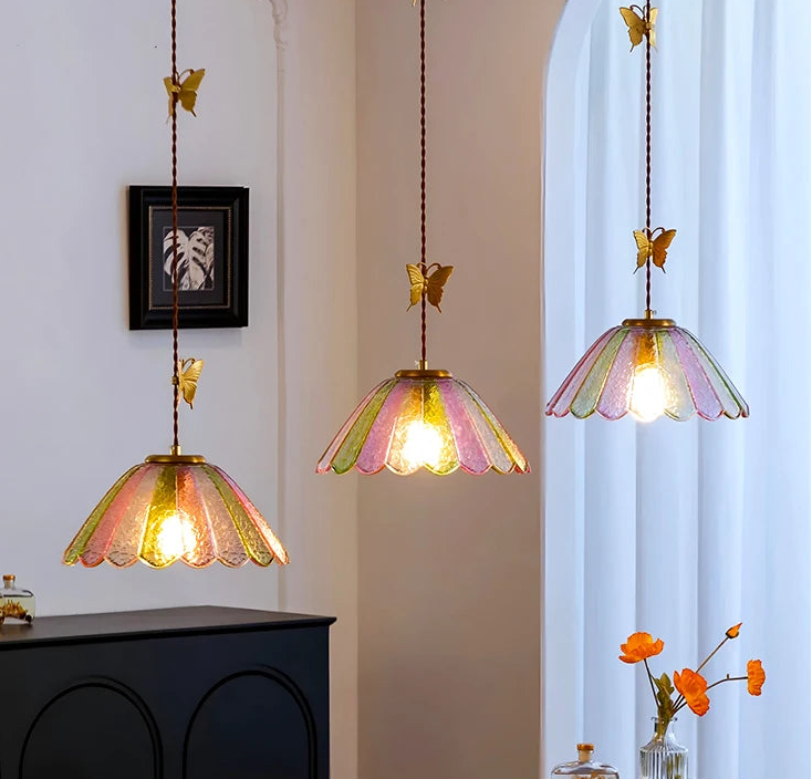 Decorative pendant lights with colorful glass shades in a room setting.