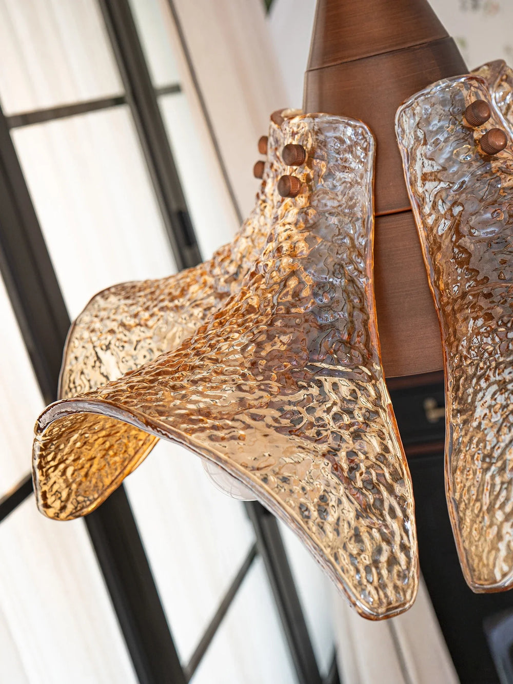 Gold high-heeled shoes with textured design on a blurred background