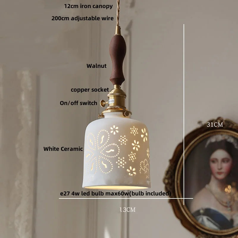 White ceramic pendant light with decorative cut-out design, labeled with dimensions and features.