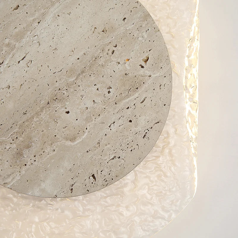 Round concrete coaster with a textured surface on a light background