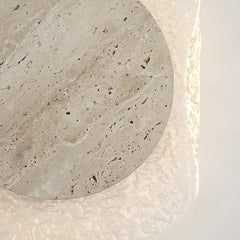 Round concrete coaster with a textured surface on a light background