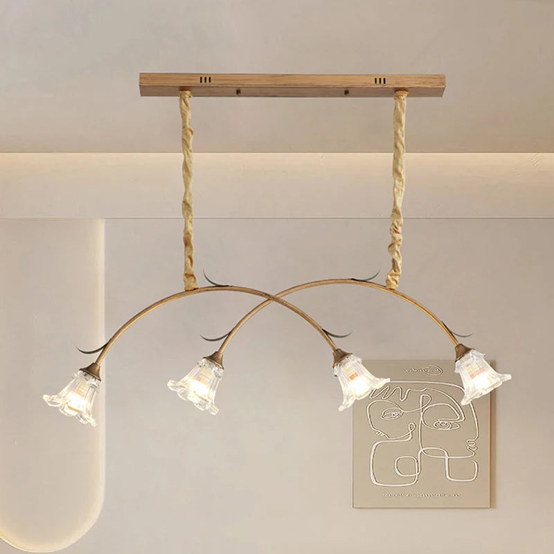 A different angle of the gold floral pendant light with glass shades, highlighting its curved design.