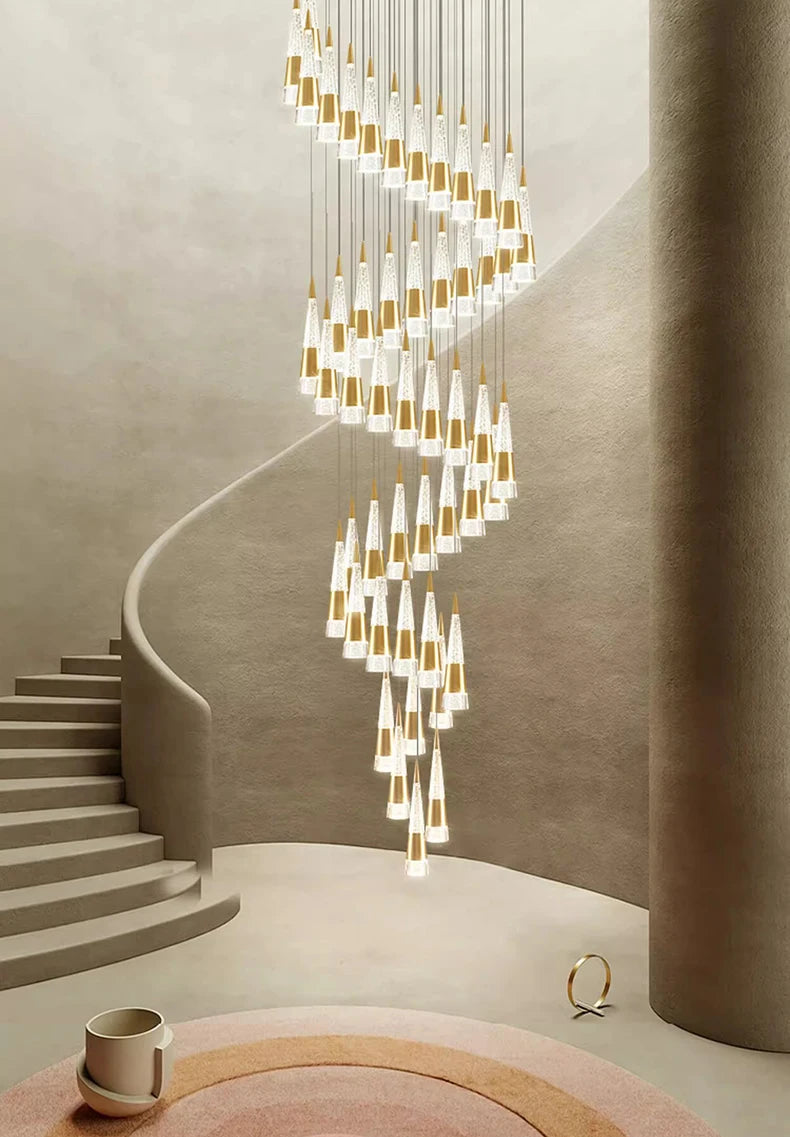 Modern chandelier hanging in a stylish interior setting with stairs and decor items.
