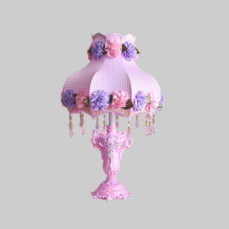 Pink decorative table lamp with floral design and measurements on a white background