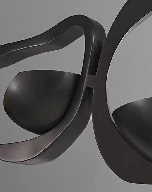 Modern black chair with wavy design on a gray background