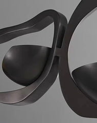 Modern black chair with wavy design on a gray background