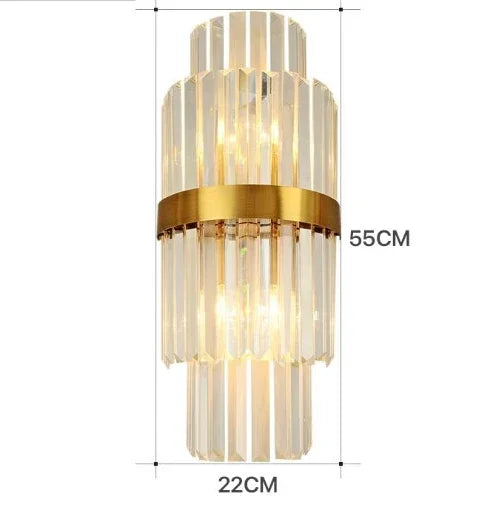 Decorative wall sconce with gold accents and clear glass panels, shown with dimensions on a white background.