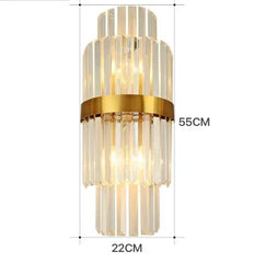 Decorative wall sconce with gold accents and clear glass panels, shown with dimensions on a white background.